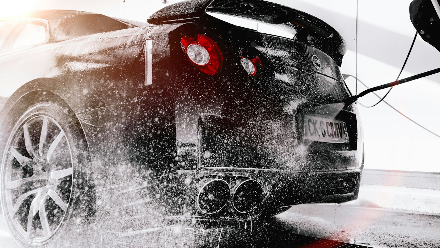 A car being rinsed in a wash bay